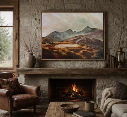 Cozy living room with fireplace, painting of mountains, and comfortable furniture.